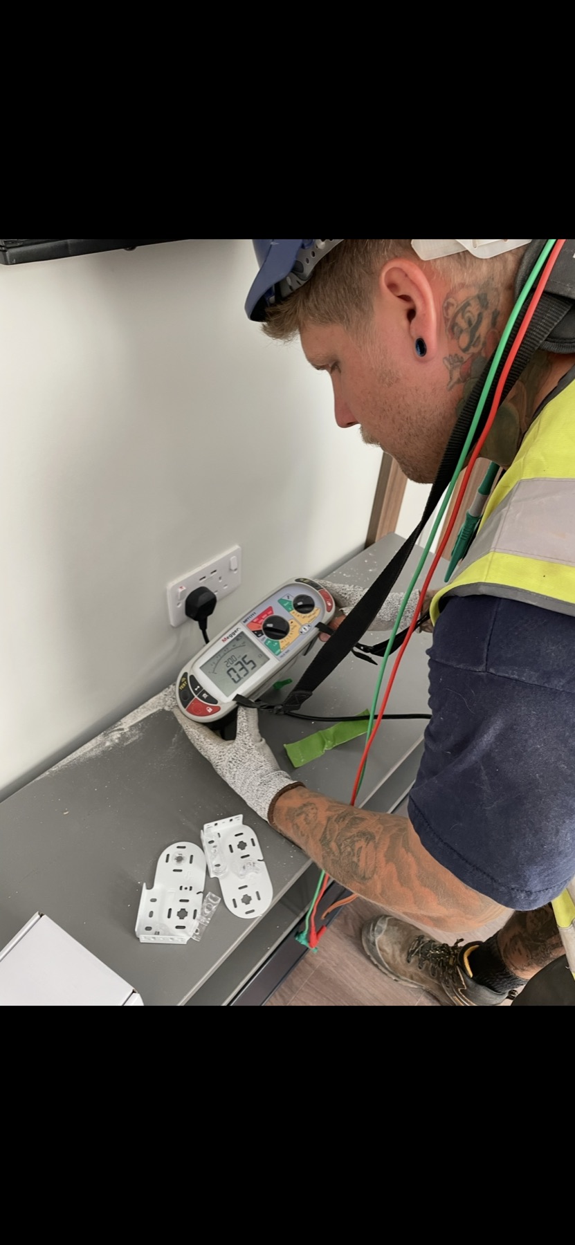 Electrician testing a socket with a multifunction tester